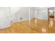 Inviting living room with hardwood floors, a staircase, and an open floor plan that leads to the kitchen and other living spaces at 1405 Merrilow Ct, Wake Forest, NC 27587