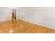 Bright living room featuring gleaming hardwood floors and an open layout, flowing seamlessly into the adjacent kitchen and dining area at 1405 Merrilow Ct, Wake Forest, NC 27587