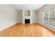 Bright living room featuring hardwood floors, fireplace, and large window at 1405 Merrilow Ct, Wake Forest, NC 27587