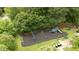 Aerial view of a neighborhood playground featuring swings, slides, and benches surrounded by lush trees at 1405 Merrilow Ct, Wake Forest, NC 27587