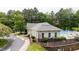 Community pool with lounge chairs surrounded by trees, offers a refreshing escape for residents at 1405 Merrilow Ct, Wake Forest, NC 27587