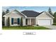 Charming one-story home with neutral siding, crisp white trim, and a two-car garage on a well manicured lawn and landscape at 145 Caspian Ct, Lillington, NC 27546