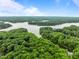 Aerial view showing the surrounding lush green landscape with a beautiful lake, offering serene and picturesque scenery at 1501 Chatsworth Ln, Raleigh, NC 27614