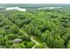 Aerial shot of beautiful wooded neighborhood with lake view in the background and showing the property's location at 1501 Chatsworth Ln, Raleigh, NC 27614