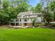 Sprawling backyard with covered patio, outdoor seating, and lush landscaping for entertaining and relaxing at 1501 Chatsworth Ln, Raleigh, NC 27614