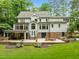 Back of home view showing outdoor entertainment space with seating, grilling area, and manicured lawn at 1501 Chatsworth Ln, Raleigh, NC 27614
