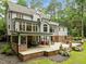 Stately home exterior with patio, outdoor seating, and multiple levels of outdoor living space at 1501 Chatsworth Ln, Raleigh, NC 27614