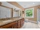 Well lit primary bathroom featuring dual sinks, shower and garden tub at 1501 Chatsworth Ln, Raleigh, NC 27614