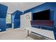 Blue bedroom with sleek white desk, mounted curved monitor, and modern fixtures at 1501 Chatsworth Ln, Raleigh, NC 27614