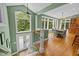 Dining area with floor-to-ceiling windows, staircase, and a view to the front entrance at 1501 Chatsworth Ln, Raleigh, NC 27614