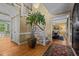 Foyer with hardwood floors, staircase, large potted plant and views into the dining room at 1501 Chatsworth Ln, Raleigh, NC 27614