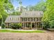 Classic brick home with manicured landscaping, dormer windows and covered front porch offers timeless curb appeal at 1501 Chatsworth Ln, Raleigh, NC 27614