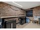 Garage with brick walls, work bench, Husky tool cabinets and painted floor at 1501 Chatsworth Ln, Raleigh, NC 27614
