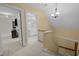Hallway with a chandelier, a view into a well-lit bathroom, and access to another room at 1501 Chatsworth Ln, Raleigh, NC 27614
