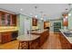 Stylish kitchen featuring custom wooden cabinets, wine cooler, and eat in barstool seating at 1501 Chatsworth Ln, Raleigh, NC 27614