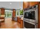 Gourmet kitchen with stainless steel appliances, wooden cabinetry, and large windows overlooking the backyard at 1501 Chatsworth Ln, Raleigh, NC 27614
