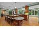 Expansive kitchen with custom wooden cabinets, large island, and multiple barstool seating options at 1501 Chatsworth Ln, Raleigh, NC 27614