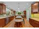 Spacious kitchen with wooden cabinetry, stainless steel appliances, and a large island at 1501 Chatsworth Ln, Raleigh, NC 27614