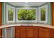 Kitchen featuring a double sink with views of a wooded backyard at 1501 Chatsworth Ln, Raleigh, NC 27614