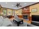 Inviting living room featuring a fireplace, wood paneling, hardwood floors and classic design elements at 1501 Chatsworth Ln, Raleigh, NC 27614
