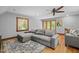 Comfortable living room with large gray sectional sofa, wood floors, area rug and natural light at 1501 Chatsworth Ln, Raleigh, NC 27614