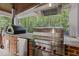 A chef-grade stainless steel grill and pizza oven are the focal point of this beautiful covered outdoor kitchen at 1501 Chatsworth Ln, Raleigh, NC 27614