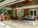 Outdoor kitchen featuring brick facade, pizza oven, grill, and patio seating for outdoor entertainment at 1501 Chatsworth Ln, Raleigh, NC 27614