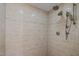 Walk-in shower featuring dual shower heads and neutral-toned ceramic tile at 1501 Chatsworth Ln, Raleigh, NC 27614