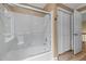 Bright bathroom with sliding glass shower doors and white subway tile at 1501 Chatsworth Ln, Raleigh, NC 27614