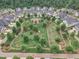 Aerial view of a community park with a garden, playground, and walking trails at 151 Bridge St, Hillsborough, NC 27278