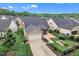 Aerial view of the home showcasing the manicured lawn, back patio, and screened porch at 151 Bridge St, Hillsborough, NC 27278