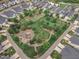 Aerial view of a community garden, fire pit, and walking trails in a neighborhood at 151 Bridge St, Hillsborough, NC 27278