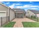 Fenced backyard with paver patio and access to the screened porch at 151 Bridge St, Hillsborough, NC 27278
