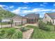 Landscaped backyard featuring a screened porch, patio, and fenced yard at 151 Bridge St, Hillsborough, NC 27278