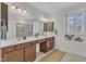 Bathroom with double sinks, tile floors, and a walk-in shower at 151 Bridge St, Hillsborough, NC 27278