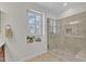 Bathroom featuring a glass shower and a window with shutters at 151 Bridge St, Hillsborough, NC 27278