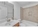 Bathroom with a combination tub and shower and wood vanity at 151 Bridge St, Hillsborough, NC 27278