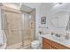 Bathroom with a glass-enclosed shower, wood vanity, and tiled walls at 151 Bridge St, Hillsborough, NC 27278