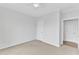 Neutral bedroom showcasing carpet flooring and two entryways at 151 Bridge St, Hillsborough, NC 27278
