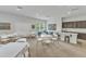A gathering area with tables, chairs, and a kitchen area offers residents space to connect at 151 Bridge St, Hillsborough, NC 27278