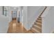 Welcoming foyer with hardwood floors, staircase, and natural light streaming through the front door at 151 Bridge St, Hillsborough, NC 27278