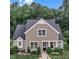 Charming home with manicured lawn, black fence, and beautiful landscaping at 151 Bridge St, Hillsborough, NC 27278