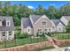 Charming home with manicured landscaping and stone wall along front yard at 151 Bridge St, Hillsborough, NC 27278