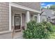 Charming front porch with a decorative wreath on the front door and lush landscaping at 151 Bridge St, Hillsborough, NC 27278