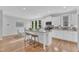 Bright kitchen featuring white cabinets, granite countertops, and a breakfast bar at 151 Bridge St, Hillsborough, NC 27278