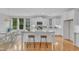 Spacious kitchen featuring an island, granite countertops, and white cabinetry at 151 Bridge St, Hillsborough, NC 27278