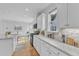 Bright kitchen featuring white cabinets, granite countertops, and stainless steel appliances at 151 Bridge St, Hillsborough, NC 27278