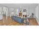 Open-concept living room with hardwood floors, fireplace, and an abundance of natural light at 151 Bridge St, Hillsborough, NC 27278