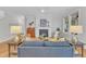 Spacious living room featuring a fireplace, hardwood floors, and bright, natural light at 151 Bridge St, Hillsborough, NC 27278