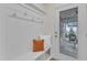 Bright mudroom features beadboard, hooks, a bench, and access to the screened porch at 151 Bridge St, Hillsborough, NC 27278